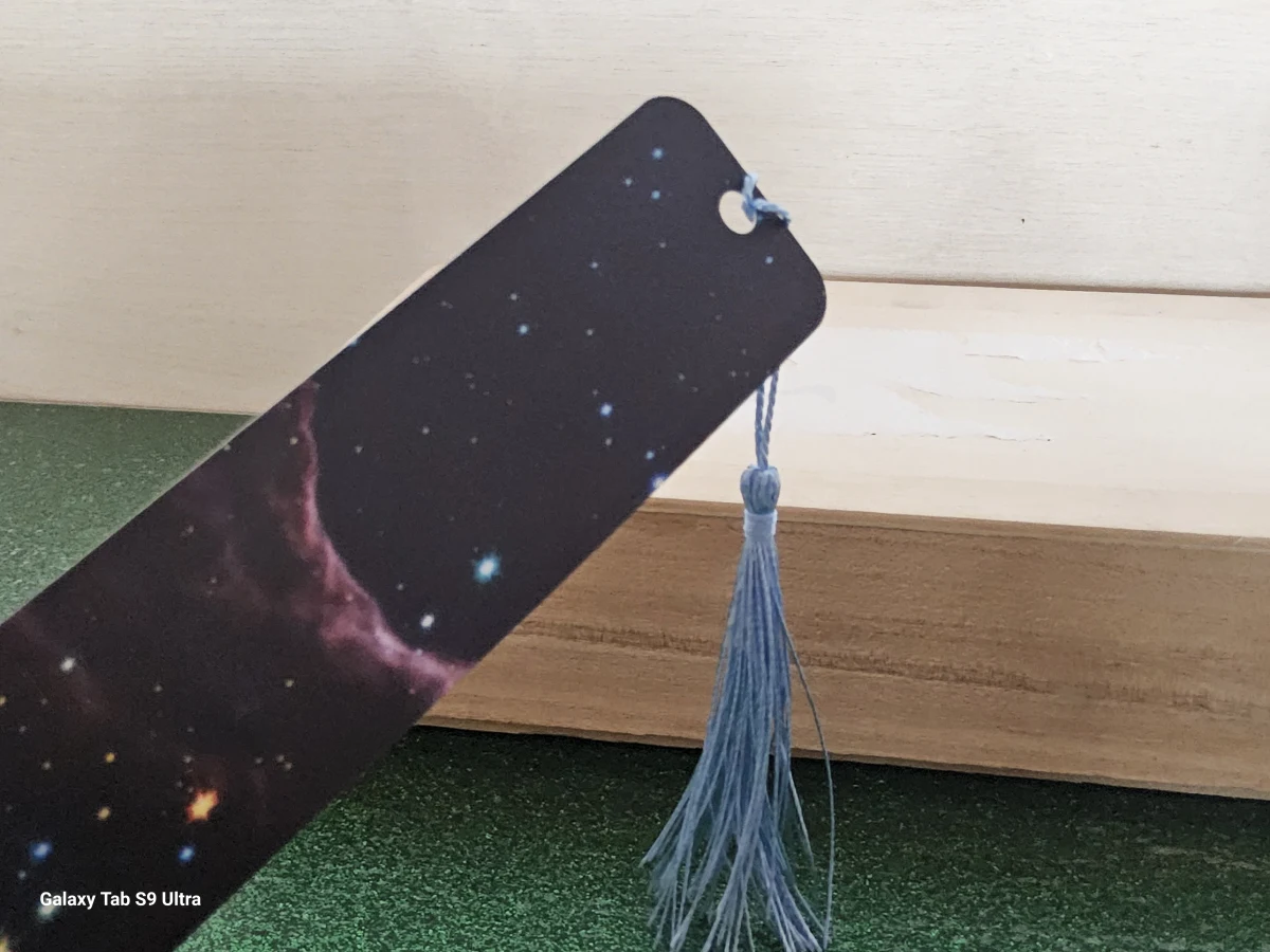 Cosmic galaxy design bookmark with blue tassel