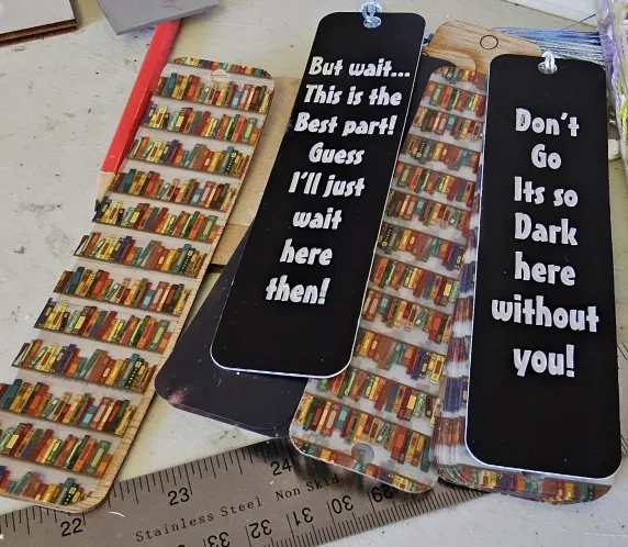 Collection of custom engraved and printed bookmarks with tassels